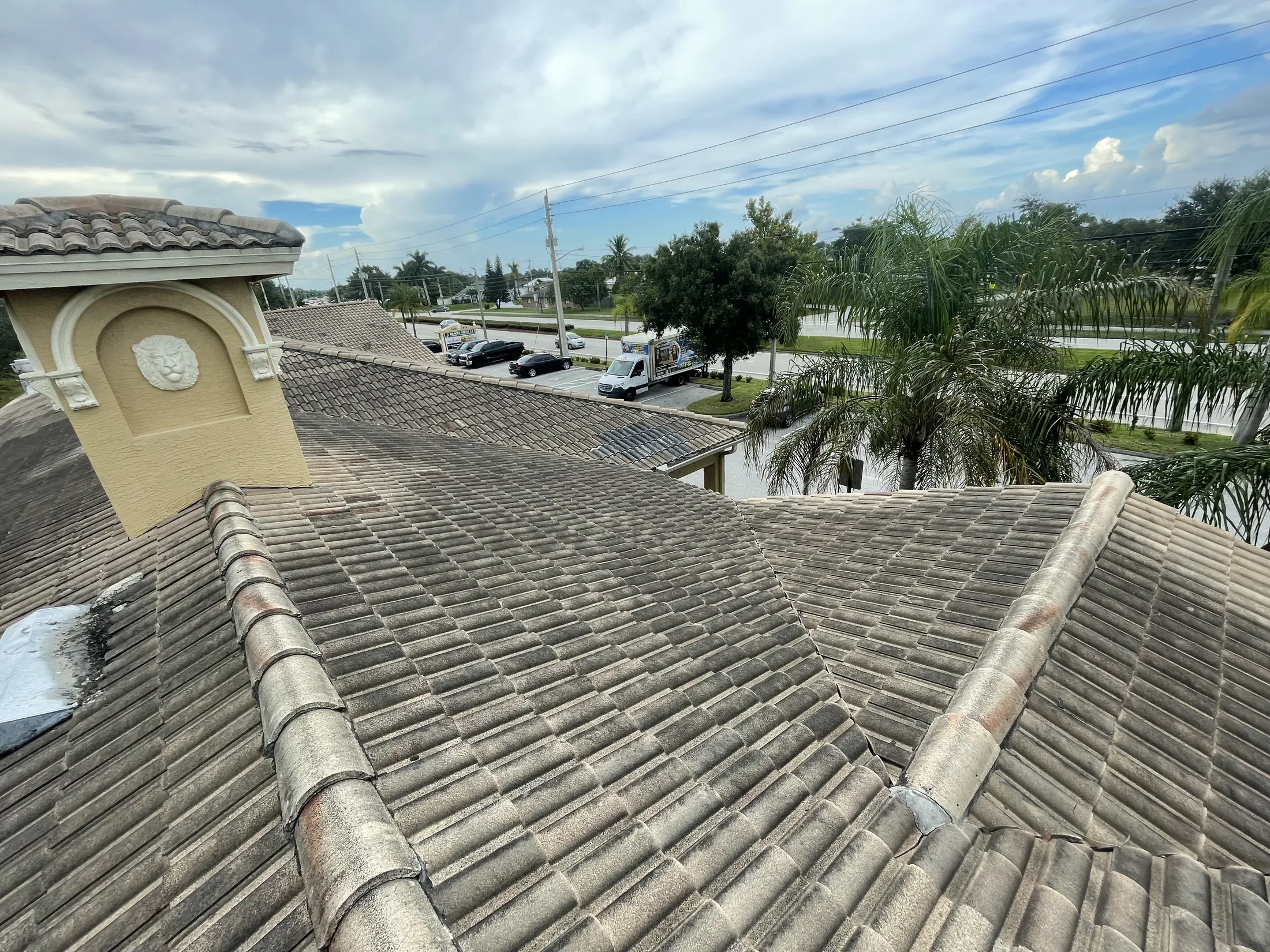 Street view of a gray tile roof before cleaning