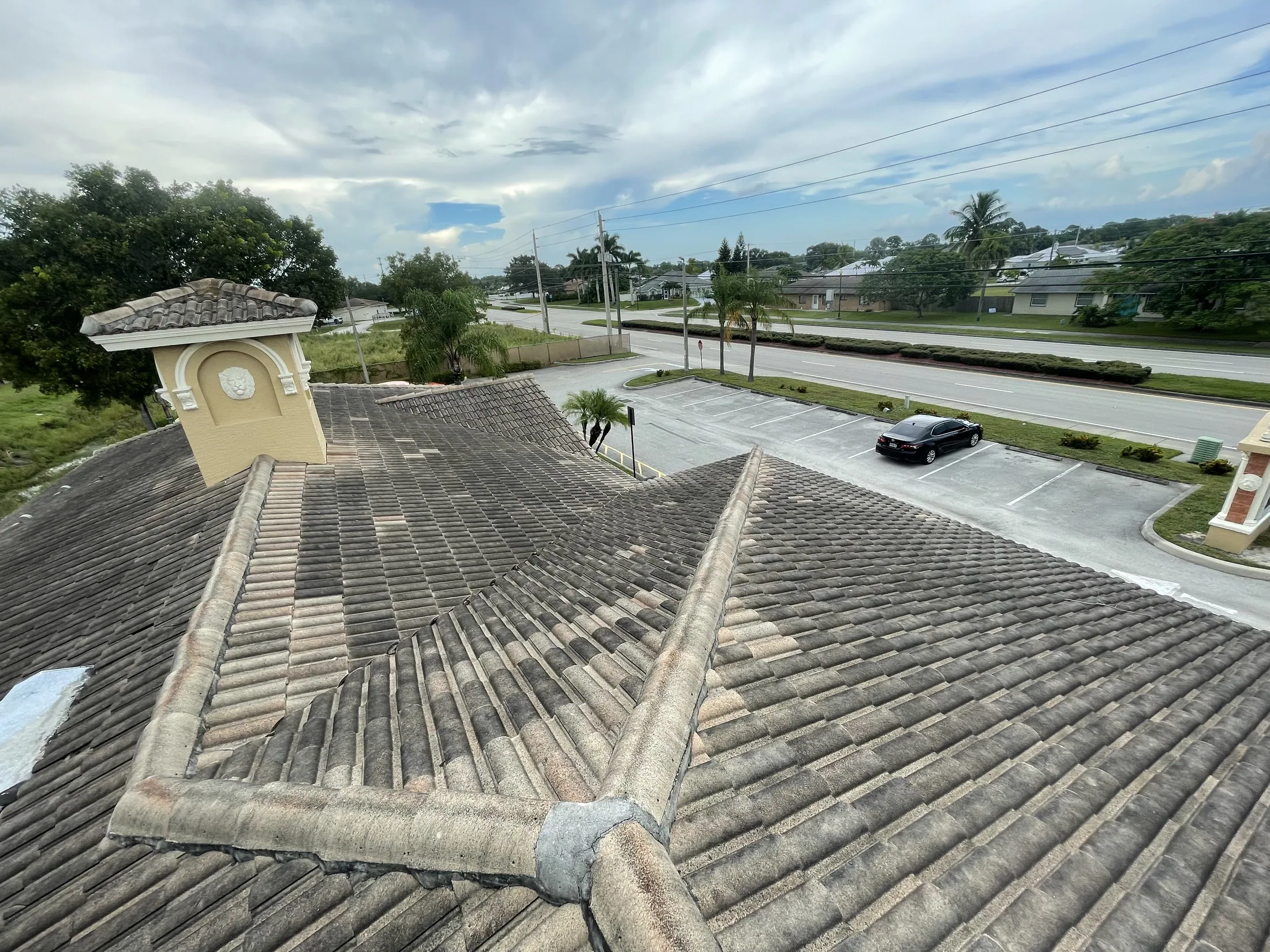 Close view of a gray tile roof ridge before cleaning