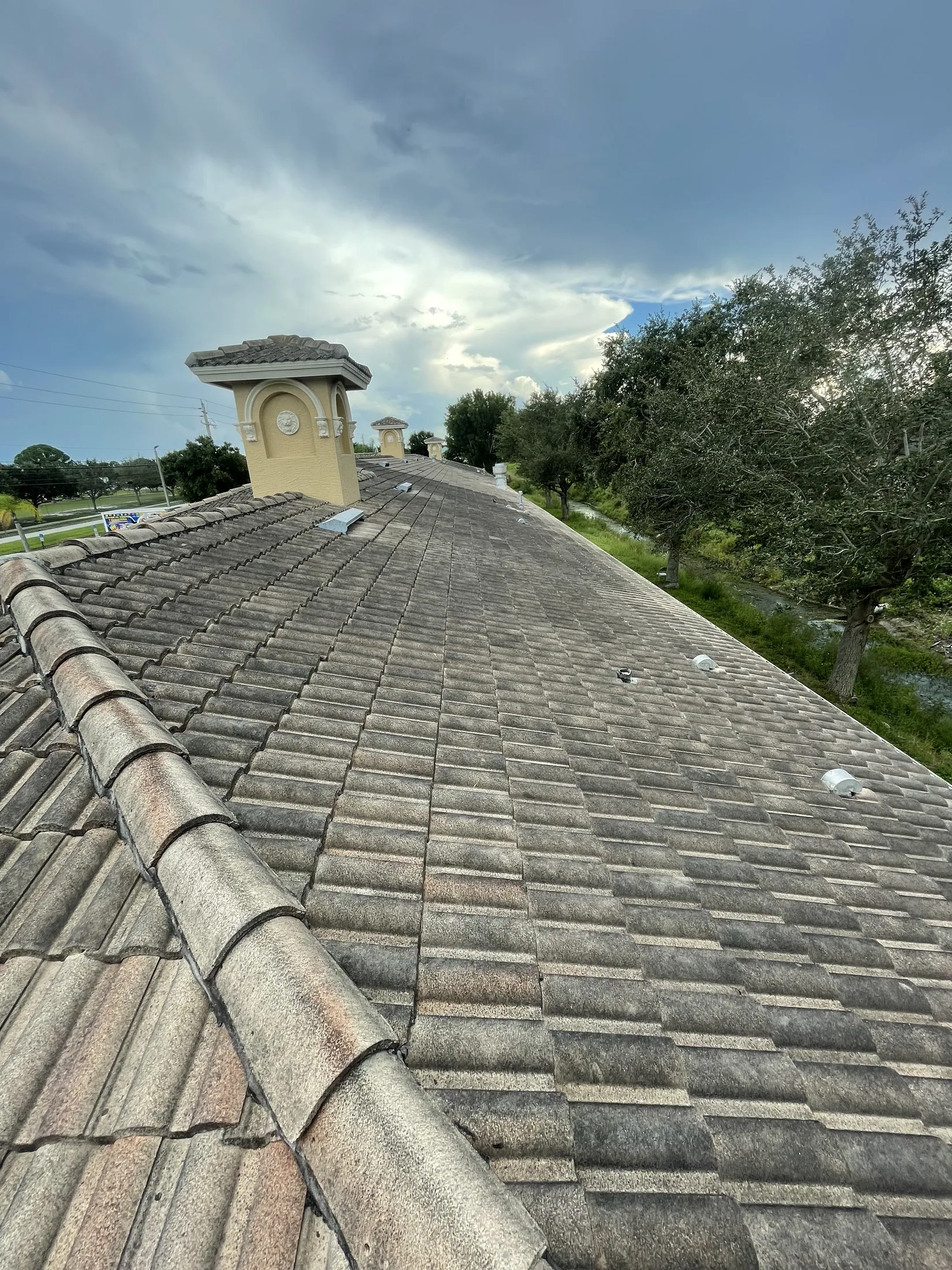 Gray tile roof slope before cleaning