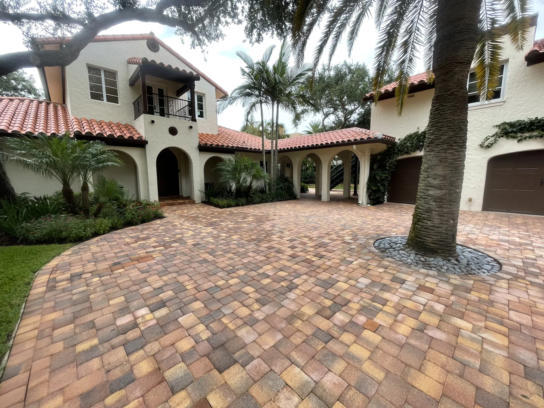 Mediterranean-style home with a paver driveway