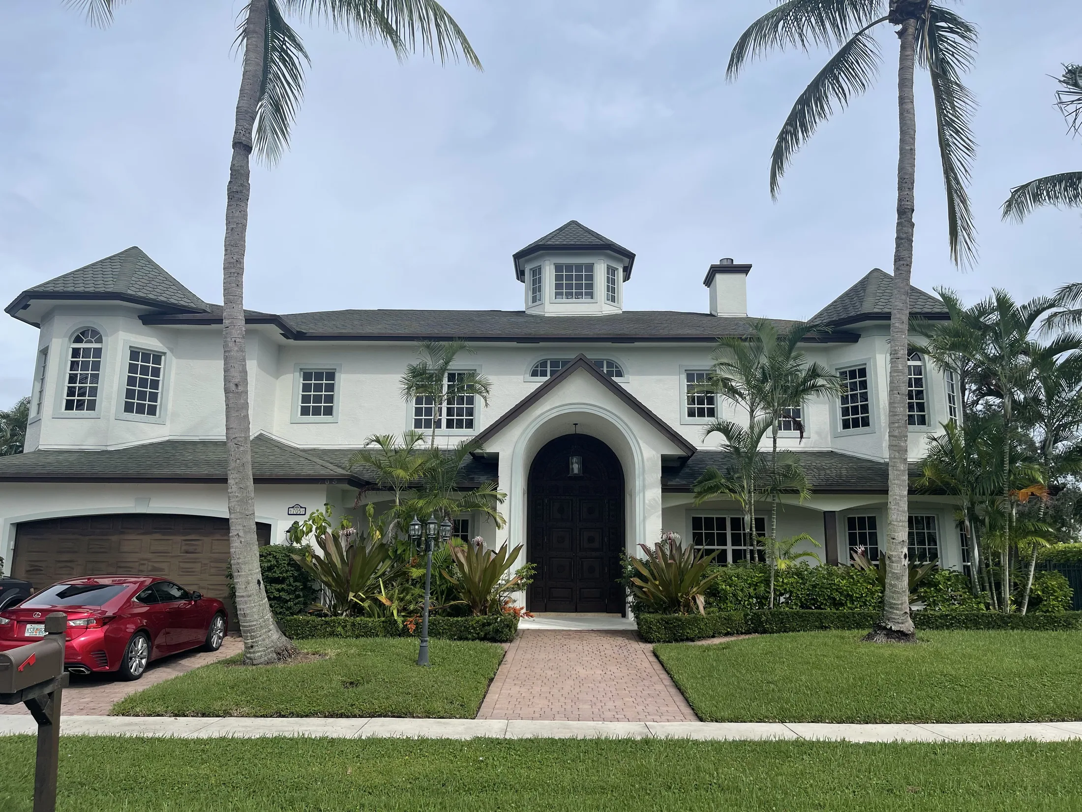 White Florida home with palm trees
